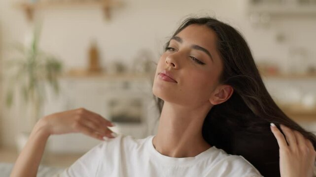 Indian woman Arabian girl Latina female lady close eyes at home enjoy cool fan blow hair fly enjoying conditioner air breeze blowing cooling temperature climate control system house apartment refresh