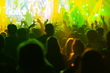 Hands holding phone and making photos on the concert.