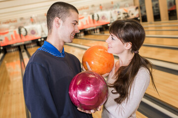 Fototapeta premium couple choosing ball at bowling alley