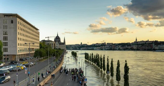 Budapest, Hungary - September 19, 2024: The Danube River overflowing its banks. Arial view to the city from the Margit Bridge. Golden hour time. Time lapse, slide transition.