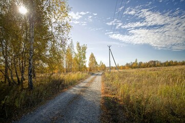 Dirt road with crushed stone in autumn
