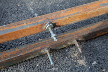 New bolt fastening in rusty metal profile