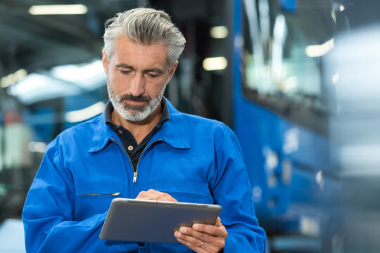 mechanic working with digital tablet
