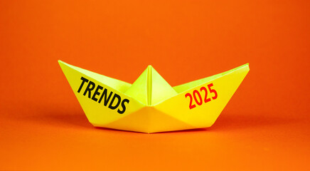 Planning trends 2025 new year symbol. Concept words Trends 2025 on beautiful yellow paper boat. Beautiful orange paper background. Business trends 2025 new year concept. Copy space.