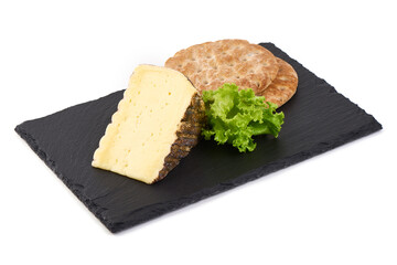 Aged cheese wedge with natural rind and lettuce, isolated on white background.