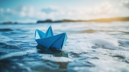 Obraz premium Blue Paper Boat Floating on Ocean Waves
