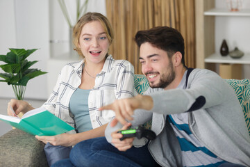 young happy smiling couple in love on the couch