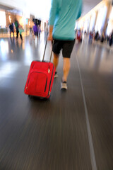 Man in Airport Walking with Red Suitcase for Traveling Modern Travel Blurred speed moving fast