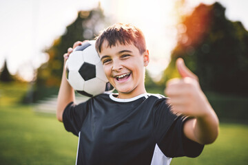 Fototapeta premium Sport, boy and football on field, trick practice and exercise for competition match. Soccer player, person and playing.