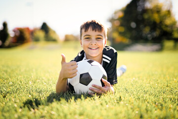 Sport, boy and football on field, trick practice and exercise for competition match. Soccer player, person and playing.