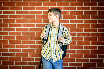 Student boy outside at school posing on autumn season