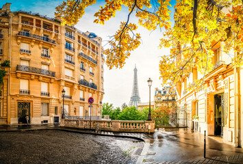 cosy Paris street with view on the famous Eiffel Tower on a cloudy autumn day, Paris France, toned