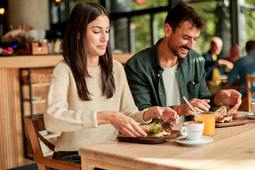 Enjoying a delightful brunch together at a cozy cafe on a sunny afternoon in the heart of the city