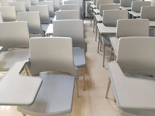 Lecture room or School empty classroom with painted chair iron wood for studying lessons in high school, interior of secondary education, vintage tone educational concept
