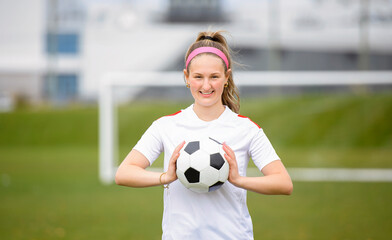 motivation soccer player with a football in a sport uniform wearing in white