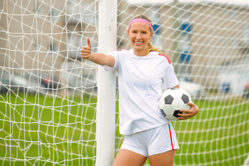 motivation soccer player with a football in a sport uniform wearing in white