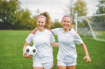 Naklejka premium two soccer player friends with a football in a sport uniform wearing in white
