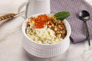 Curd with granola and orange jam