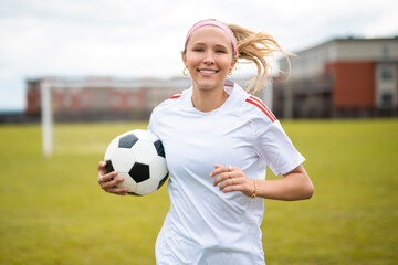 motivation soccer player with a football in a sport uniform wearing in white