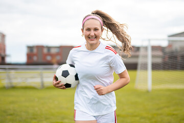 motivation soccer player with a football in a sport uniform wearing in white