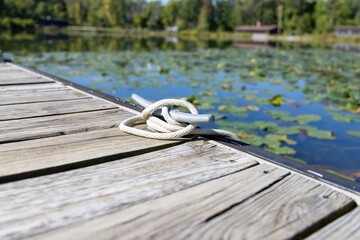 Fototapeta premium rope on wooden dock in pond 