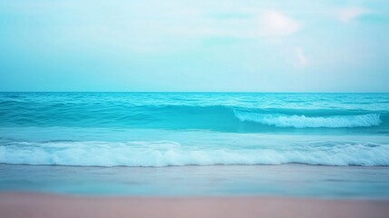 Fototapeta premium A blurred background of ocean waves rolling towards the shore, shot in natural light to create a soft, serene atmosphere. 