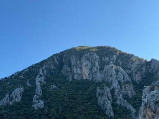 a view of the summit of a large mountain with a blue sky in the background