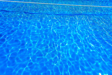 Obraz premium Blue ripped water in swimming pool as background