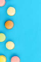 Macarons design on blue background top view space for text