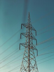 Close Up View Of A High Voltage Tower With sunny Weather And Blue Sky. Big Sized Metal Frame Tower. Big Sized Electricity Pylon, Pylon.