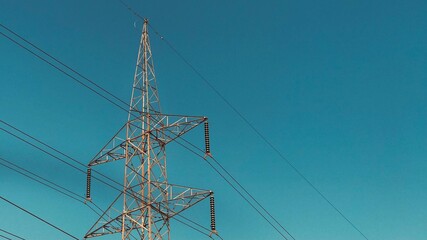 Close Up View Of A High Voltage Tower With sunny Weather And Blue Sky. Big Sized Metal Frame Tower. Big Sized Electricity Pylon, Pylon.