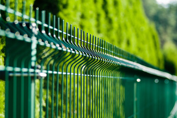 metal sectional fence close-up on green background