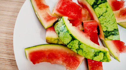 Close-up of watermelon rinds on a plate, symbolizing summer picnics and food waste awareness