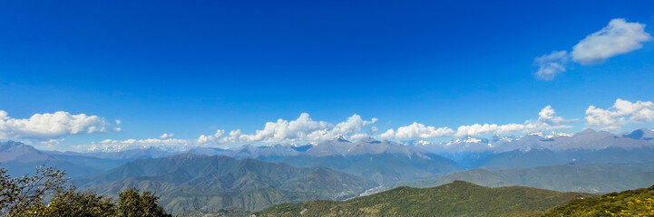Obraz premium Panoramic view of the majestic Himalayas against a clear blue sky, perfect for exploring concepts of tranquility and nature tourism