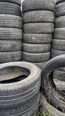 A stack of used tires piled high symbolizes recycling and environmental challenges in waste management