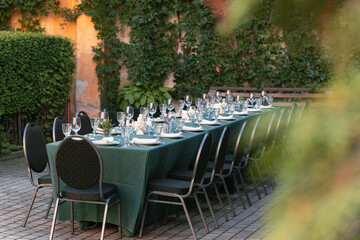 served table empty cutlery plates and drinking glass outdoor manor old back garden yard spring time...