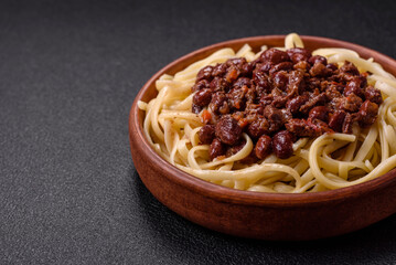 Rice noodles with beans, meat, tomato sauce, spices and herbs