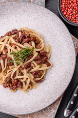 Rice noodles with beans, meat, tomato sauce, spices and herbs