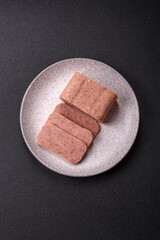 Delicious canned pink spiced ham or spam with salt, spices and herbs