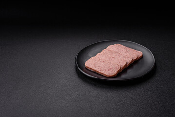 Delicious canned pink spiced ham or spam with salt, spices and herbs