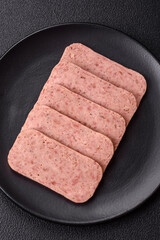 Delicious canned pink spiced ham or spam with salt, spices and herbs