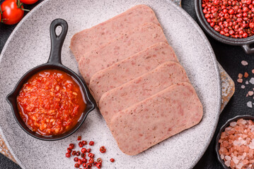 Delicious canned pink spiced ham or spam with salt, spices and herbs