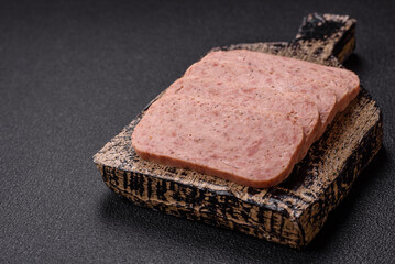 Delicious canned pink spiced ham or spam with salt, spices and herbs