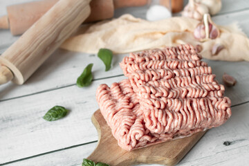 Raw minced meat , ingredients for cooking. on wooden background.