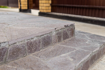 Steps on the porch are lined with stone. Cladding the porch with stone. Natural