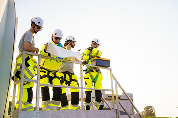 Team of electrical engineer is perform the inspection and maintenance of electric generating windmill turbine.
