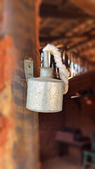 Old metal kerosene lantern attached to a wooden frame