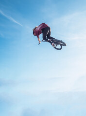 Spectacular jump of a man on a trail bike with the sky on the horizon