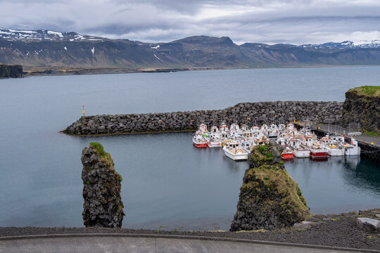 Rows of boats moored in a harbour with a mountain backdrop, Arnarstapi, Snaefellsnes Peninsula, Iceland
