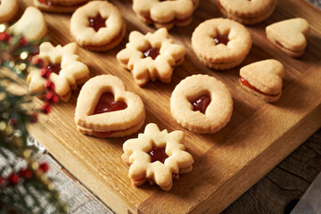 Christmas baking - traditional Linzer cookies filled with red marmalade